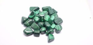 Malachite Stone Tumbles are small, polished stones made from the mineral malachite, featuring vibrant green hues and unique patterns, often used in crystal healing and decorative purposes